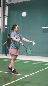 A woman standing on top of a tennis court holding a racquet
