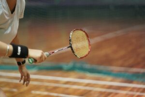 A woman holding a tennis racquet on top of a tennis court