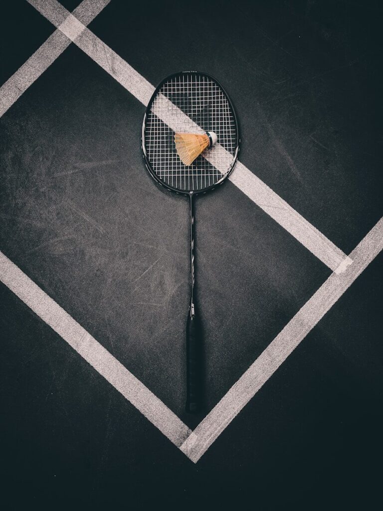 a tennis racket with a piece of cheese on it