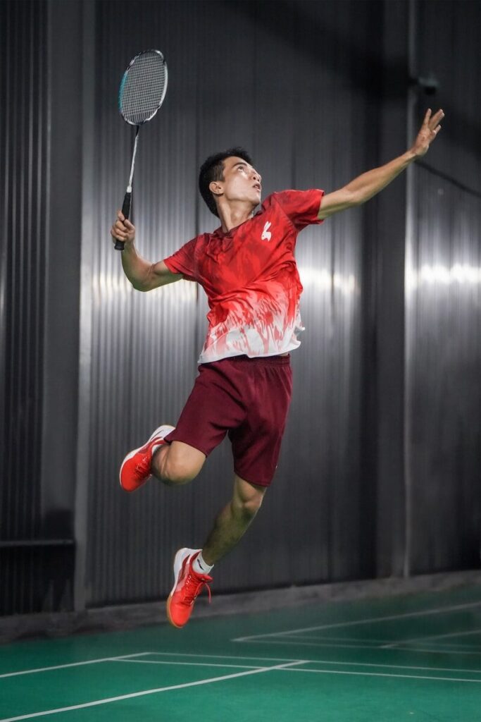 A man jumping in the air with a badminton racket
