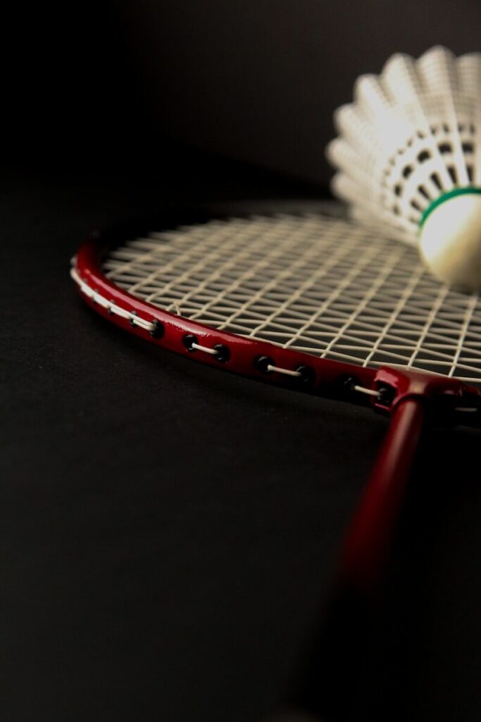 A close up of a tennis racket and a ball